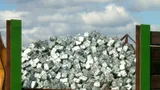 Container piled with compressed bales of aluminum cans
