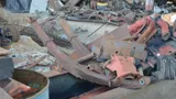 Rusty vehicle leaf springs and heavy steel parts in a scrap yard pile