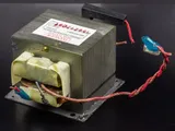 Microwave oven transformer: a laminated steel core with copper windings and wire leads