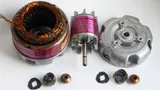 Small electric motor taken apart into its wound stator, rotor, and aluminum end housing