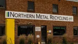 Front of a metal recycling office with an Outbound Scale sign by the door